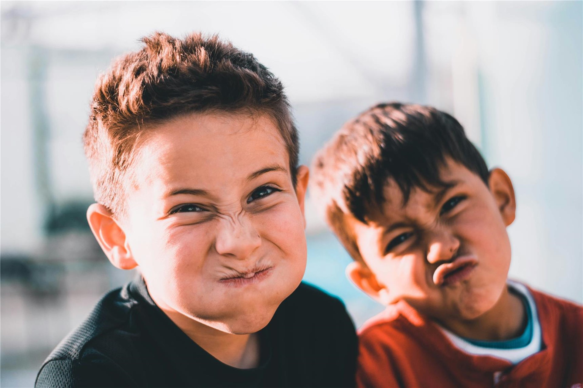 Zwei Jungs, ca. 9-10 Jahre alt verziehen die Gesichter lustig